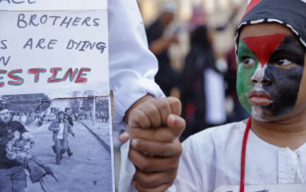 Un enfant d&#039;Afrique du Sud, maquillé avec le drapeau de la Palestine. Cape Town, 2014. / Keystone